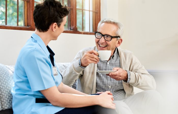 Shot of a nurse caring for a senior patient in a retirement home
