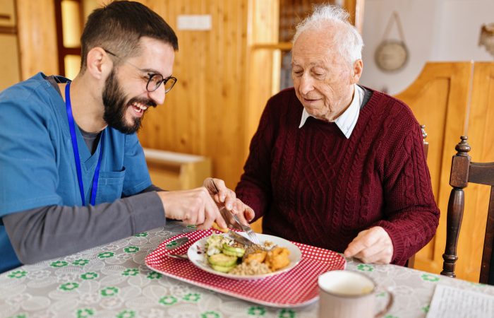Home caretaker – man helping senior man